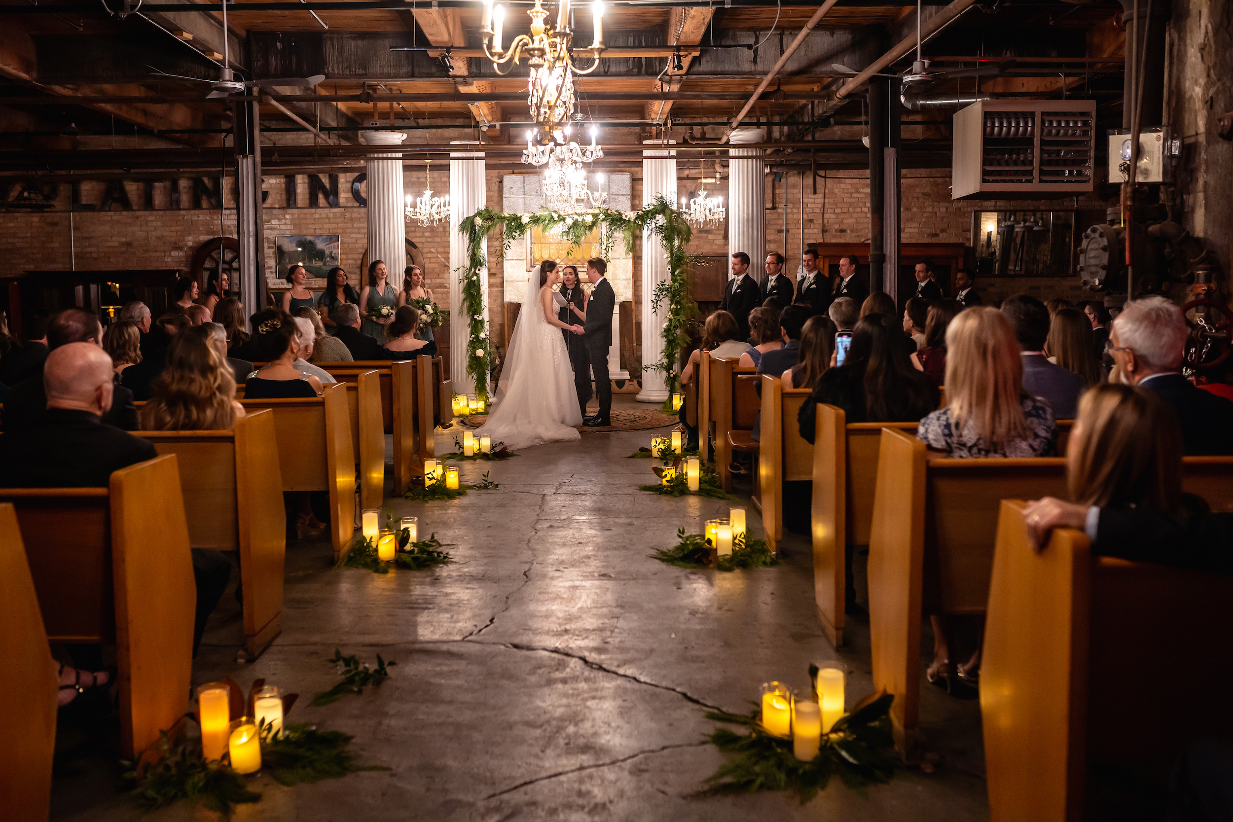 Bride and groom get married by candle light at Salvage One in Chicago.