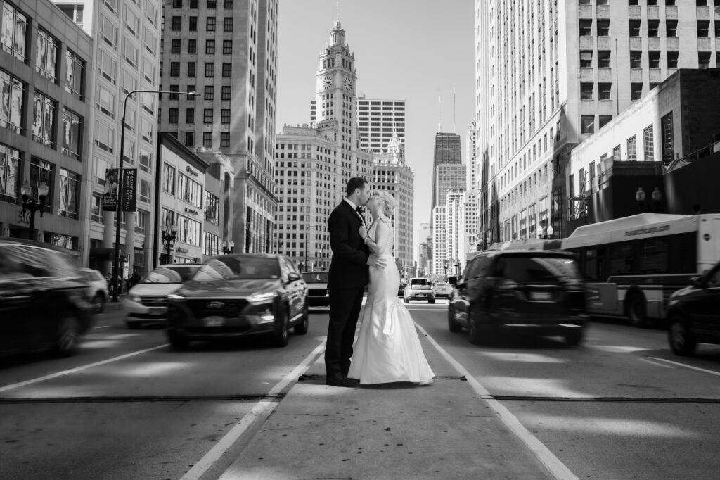 Bride and groom kiss in the middle of Michigan Ave.