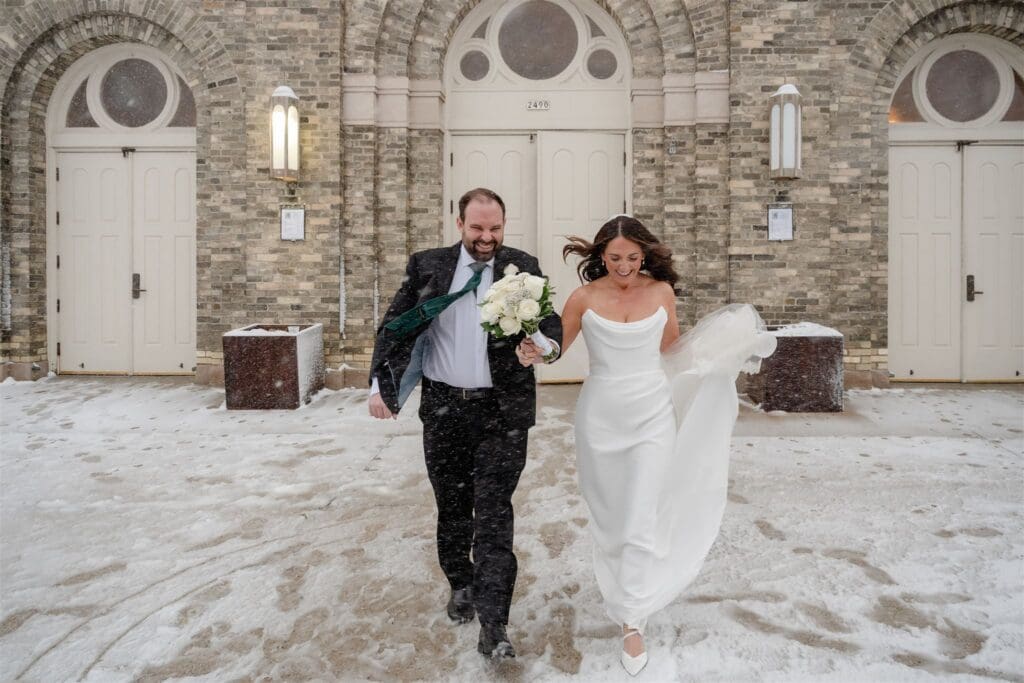 Bride and groom run out of church in a blizzard in Milwaukee.