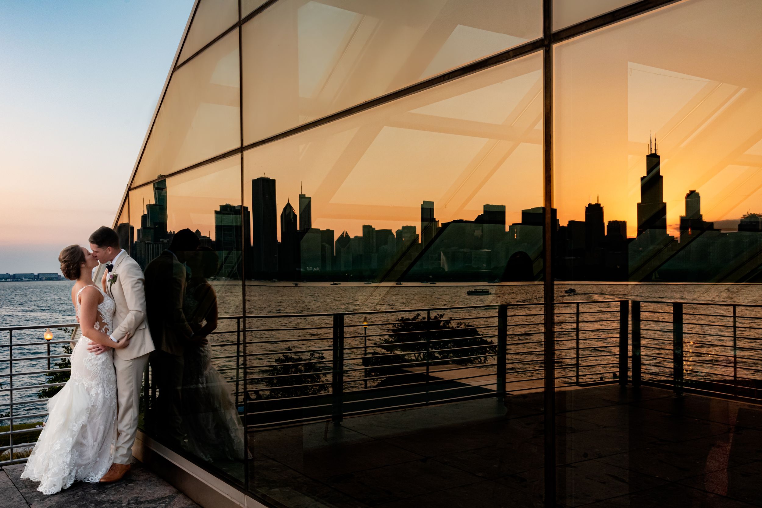 Bride and Groom portrait at the Chicago adler planetarium with the chicago skyline at sunset