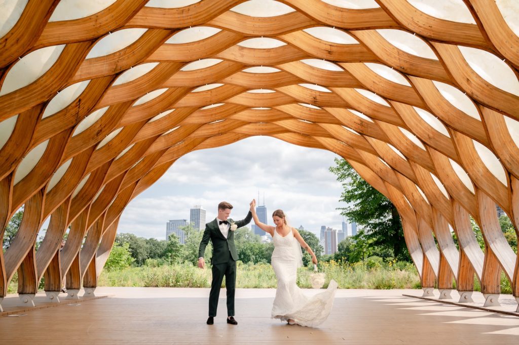 Bride and groom dance underneath honeycomb