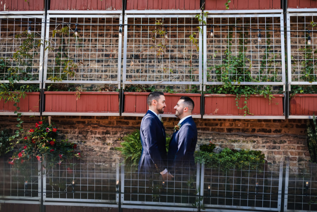 LGBTQ couple get married outside in the garden at Homestead on the Roof in Chicago, IL
