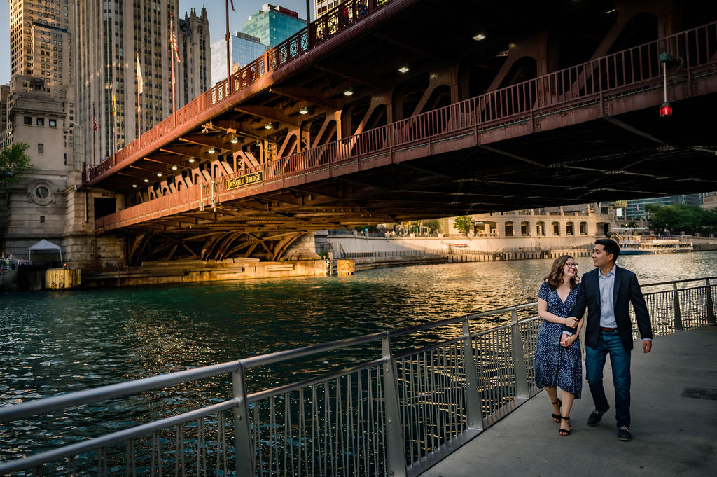 Couple walks under bridge on the Chicago Riverwalk