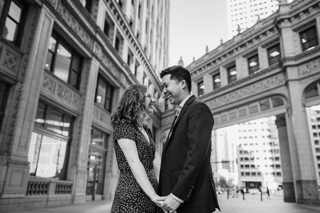 A couple hold hands at the Chicago Wrigley Building