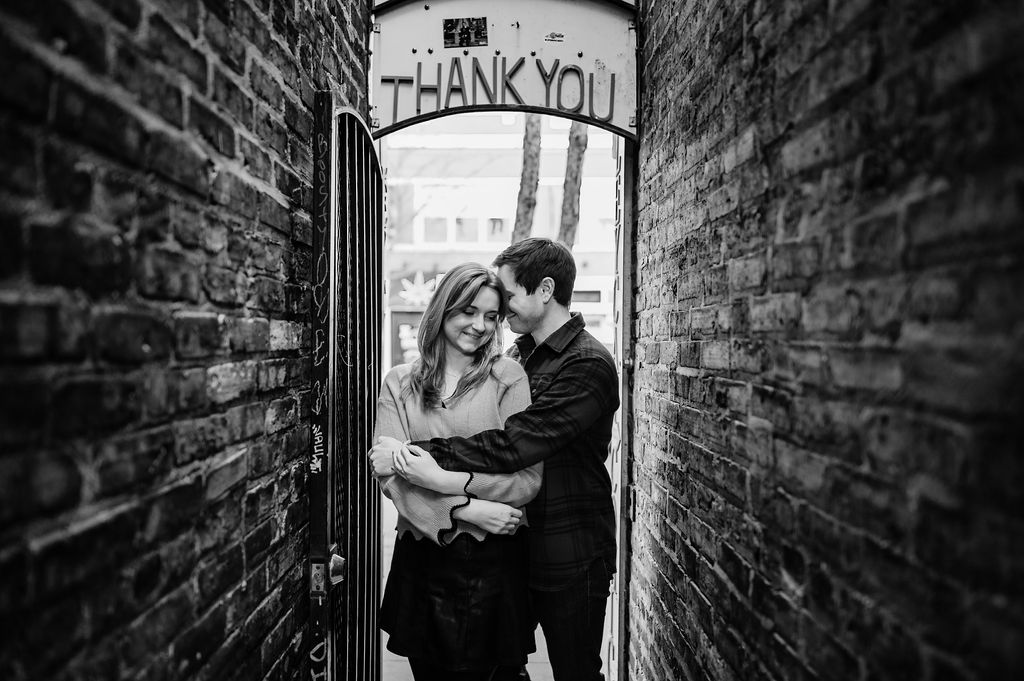  A couple embrace under a thank you sign in Ravenswood. 