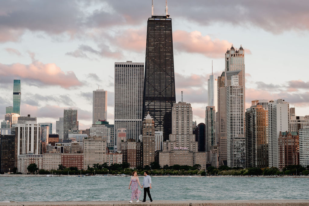 A couple walk on the pier at North Avenue Beach in Chicago at sunset