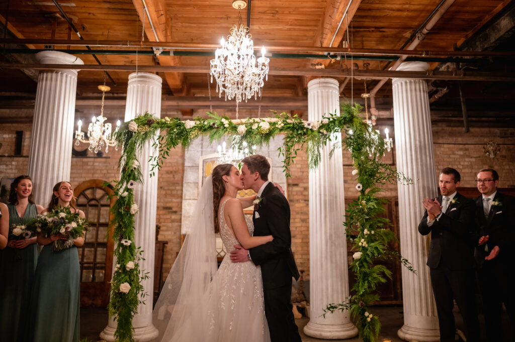 Bride and Groom share their first kiss at Salvage One in Chicago
