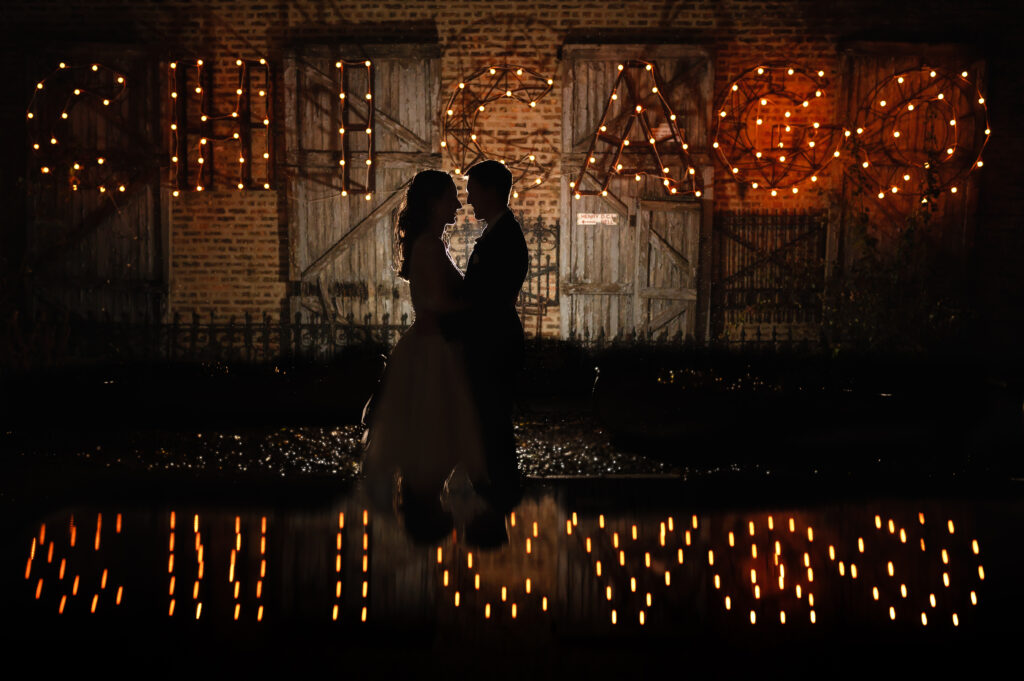 Silhouette of Bride and Groom with Chicago sign at Salvage One in Chicago.