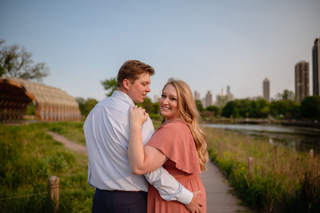 A couple embrace at Lincoln Park during their engagement session.