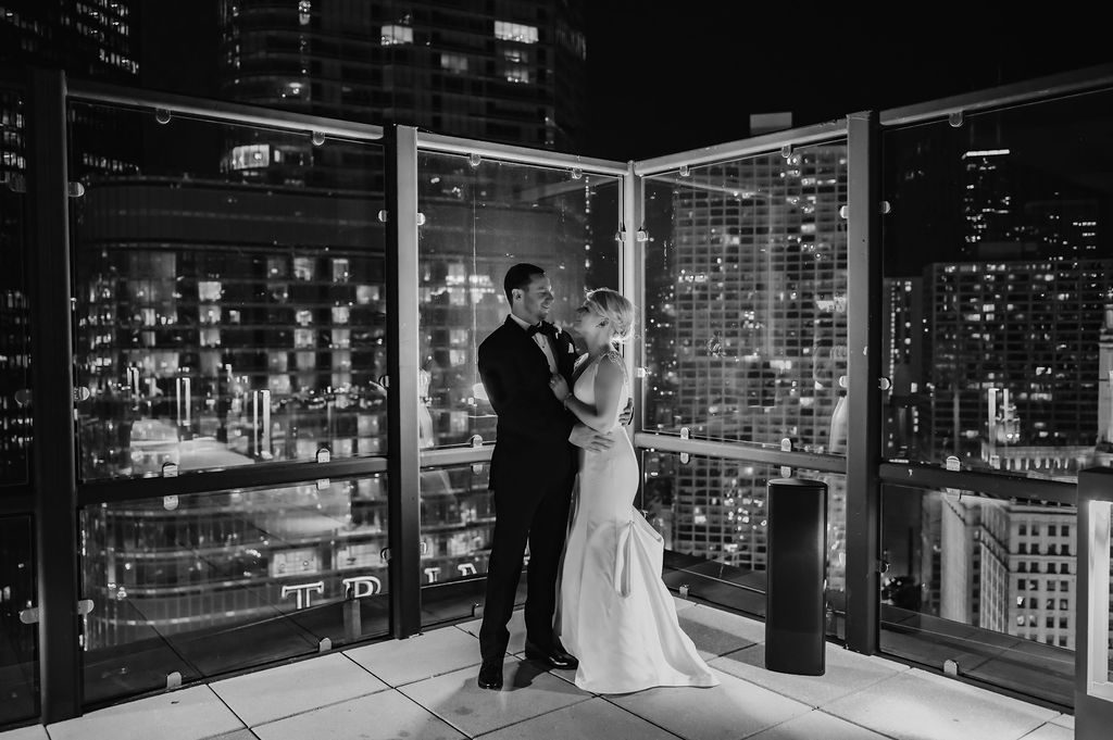 Bride and groom on rooftop of Royal Sonseta Downtown Chicago at wedding reception.