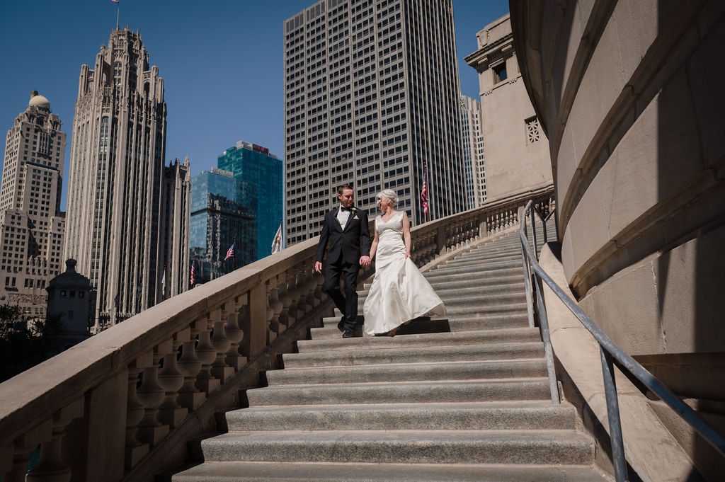 Bride and groom walk down the stairs on the Chicago Riverwalk