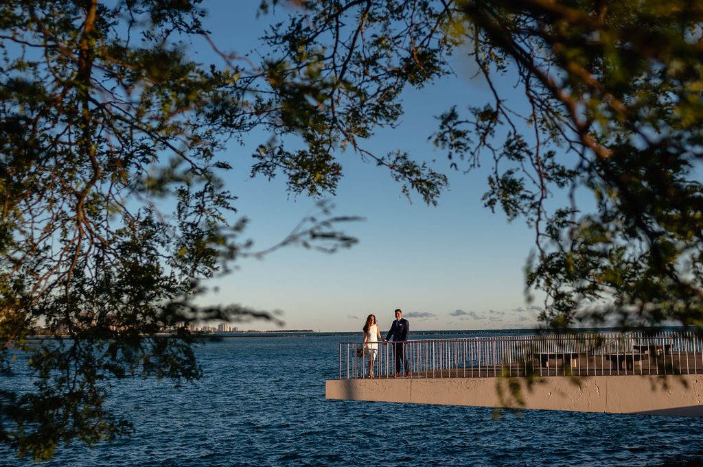 A couple hold hands during sunrise at Milton Lee Olive Park in Chicago, IL