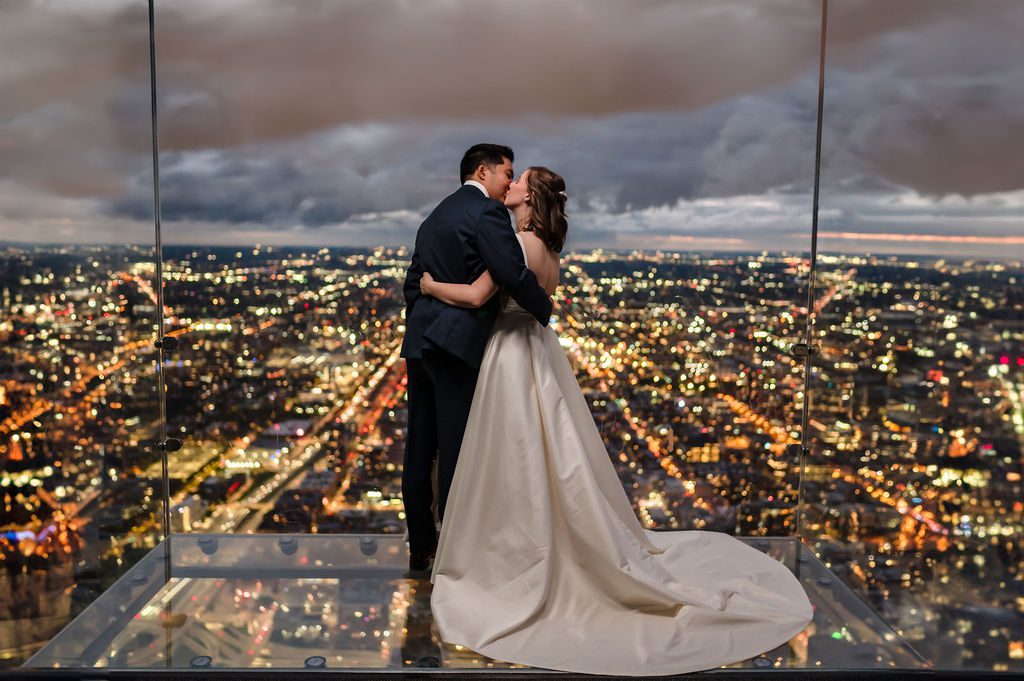 Bride and Groom kiss on The Ledge at Willis Tower in Chicago, IL