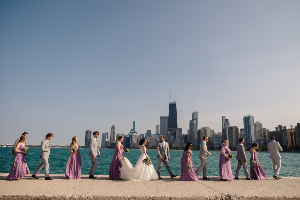 Wedding party walk in a line at North Avenue Beach