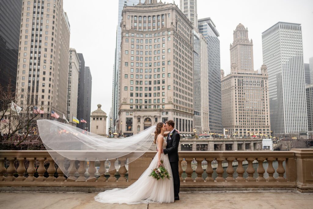 Brides veil blows in. the wind on the Chicago Riverwalk 