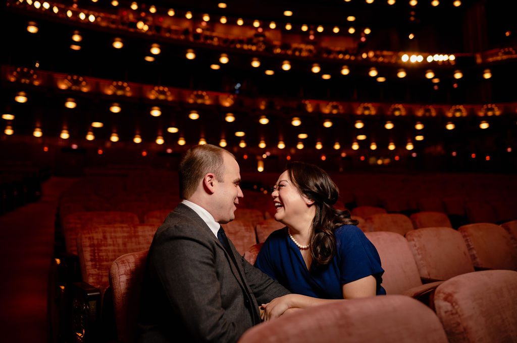 A couple sit in the seats at Lyric Opera House in Chicago.