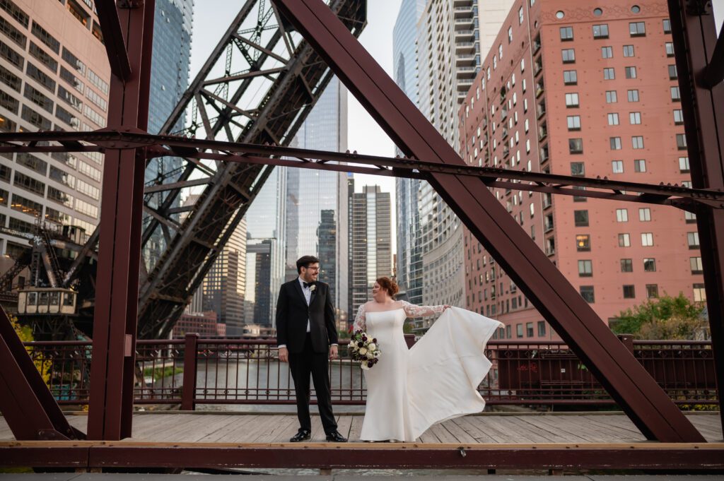 Bride and groom stand on Kinzie Bridge in Chicago