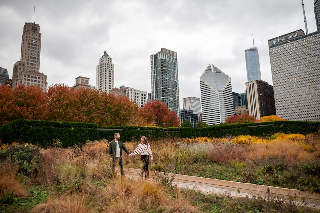 Couple hold hands in the Lurie Garden

