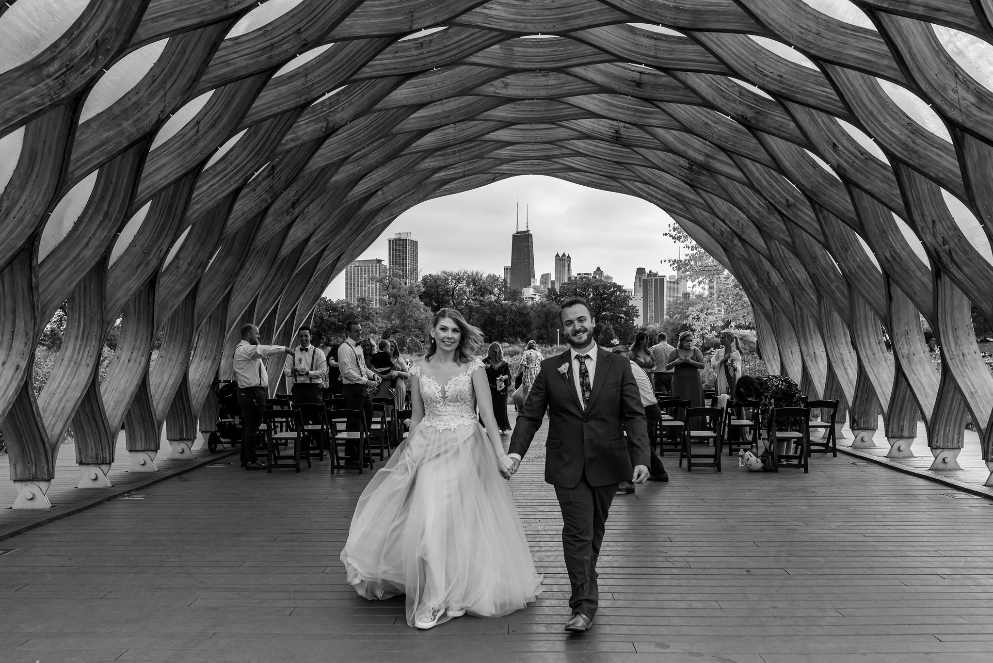 Bride and groom walk away after getting married underneath the Honeycomb in Chicago, IL