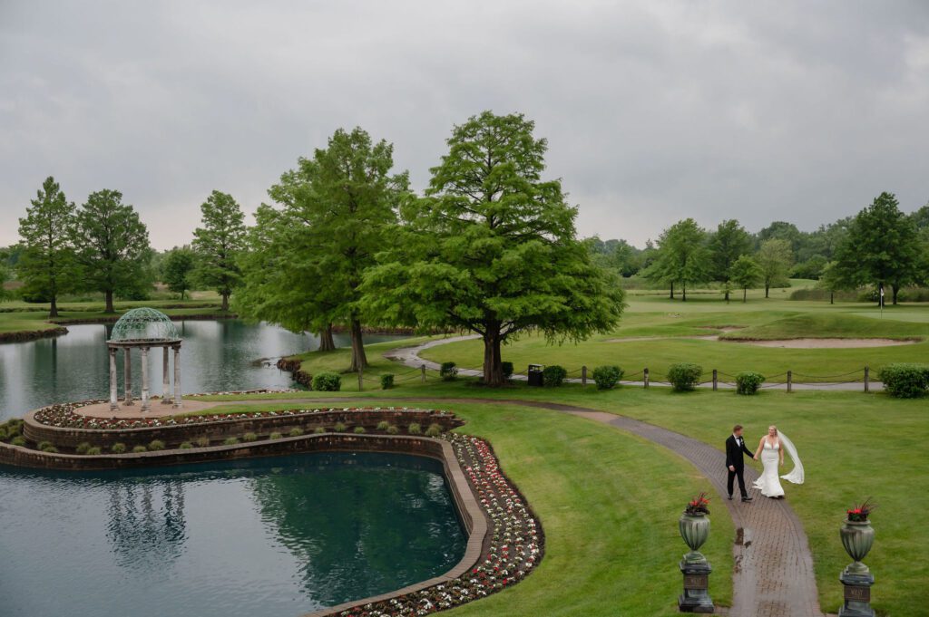 Bride and groom walk on the golf course at The Odyssey Venue in Tinley Park, Illinois.