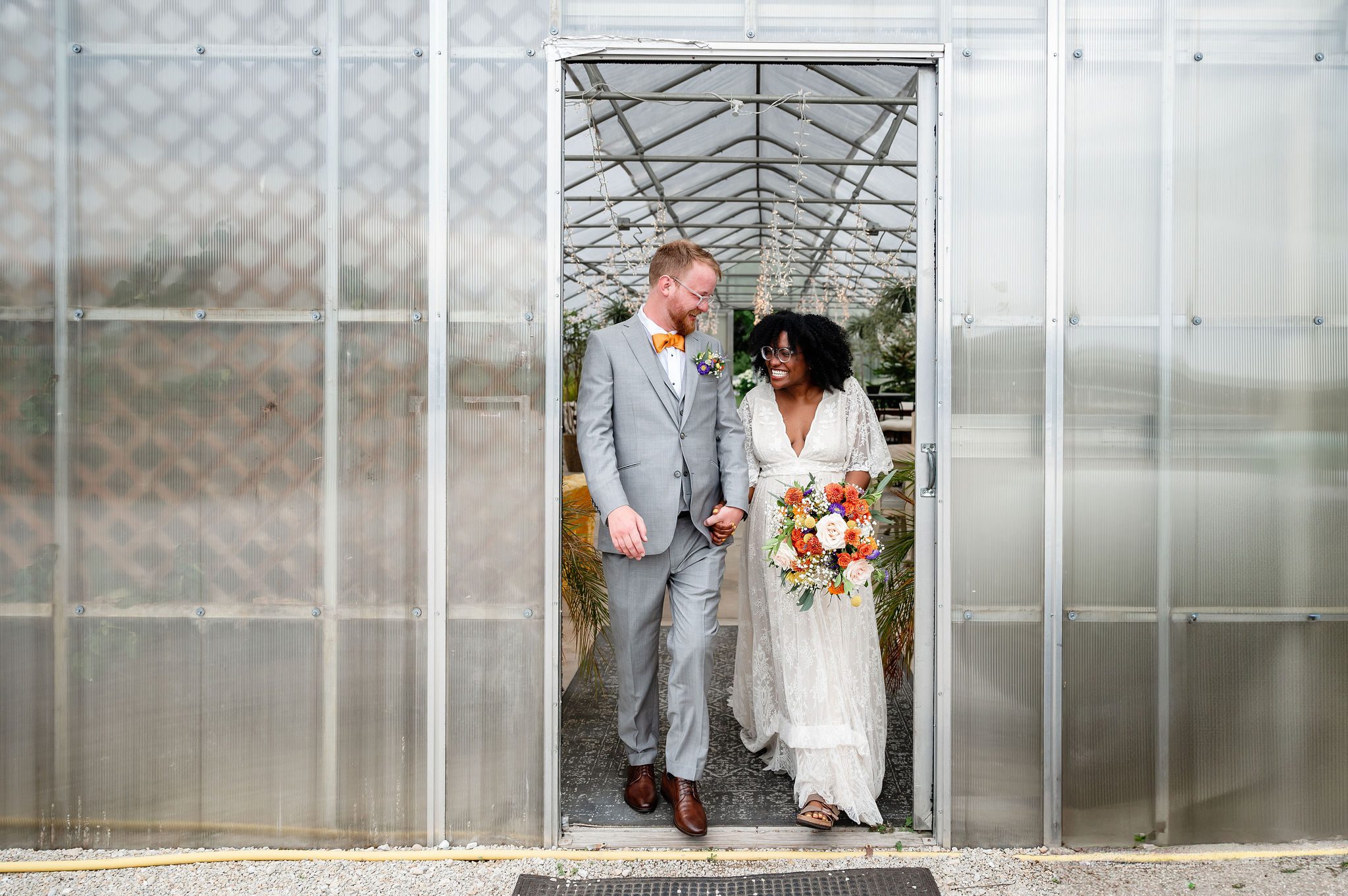 Bride and groom hold hand walking at Heritage Prairie Farm