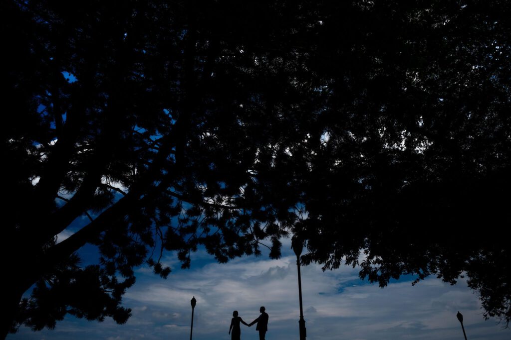 Bride and groom walk on a hill 