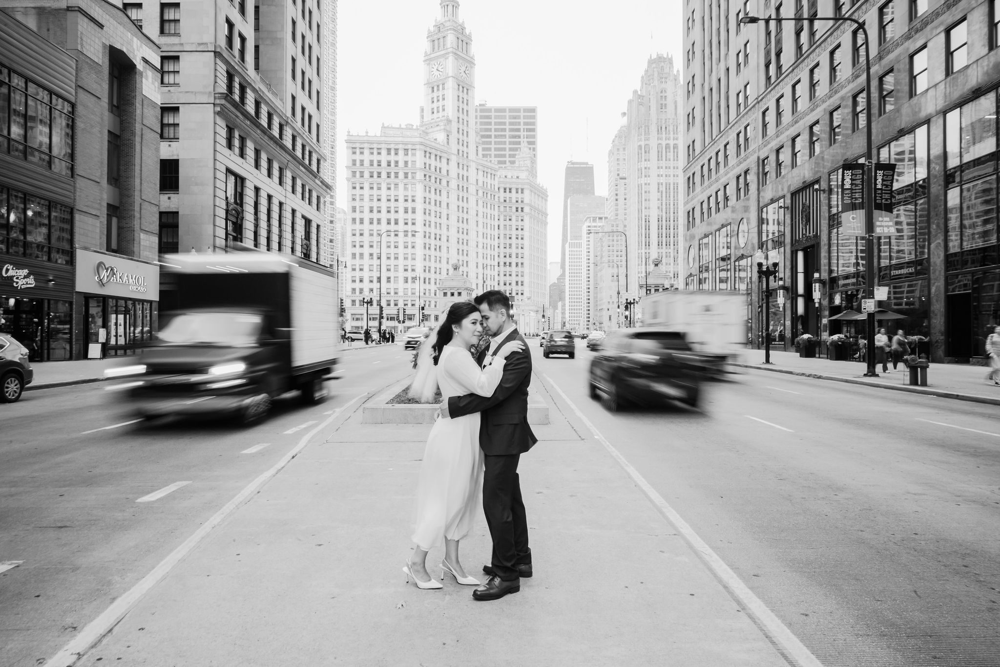 A bride and groom cross Michigan Ave. In Chicago, IL.