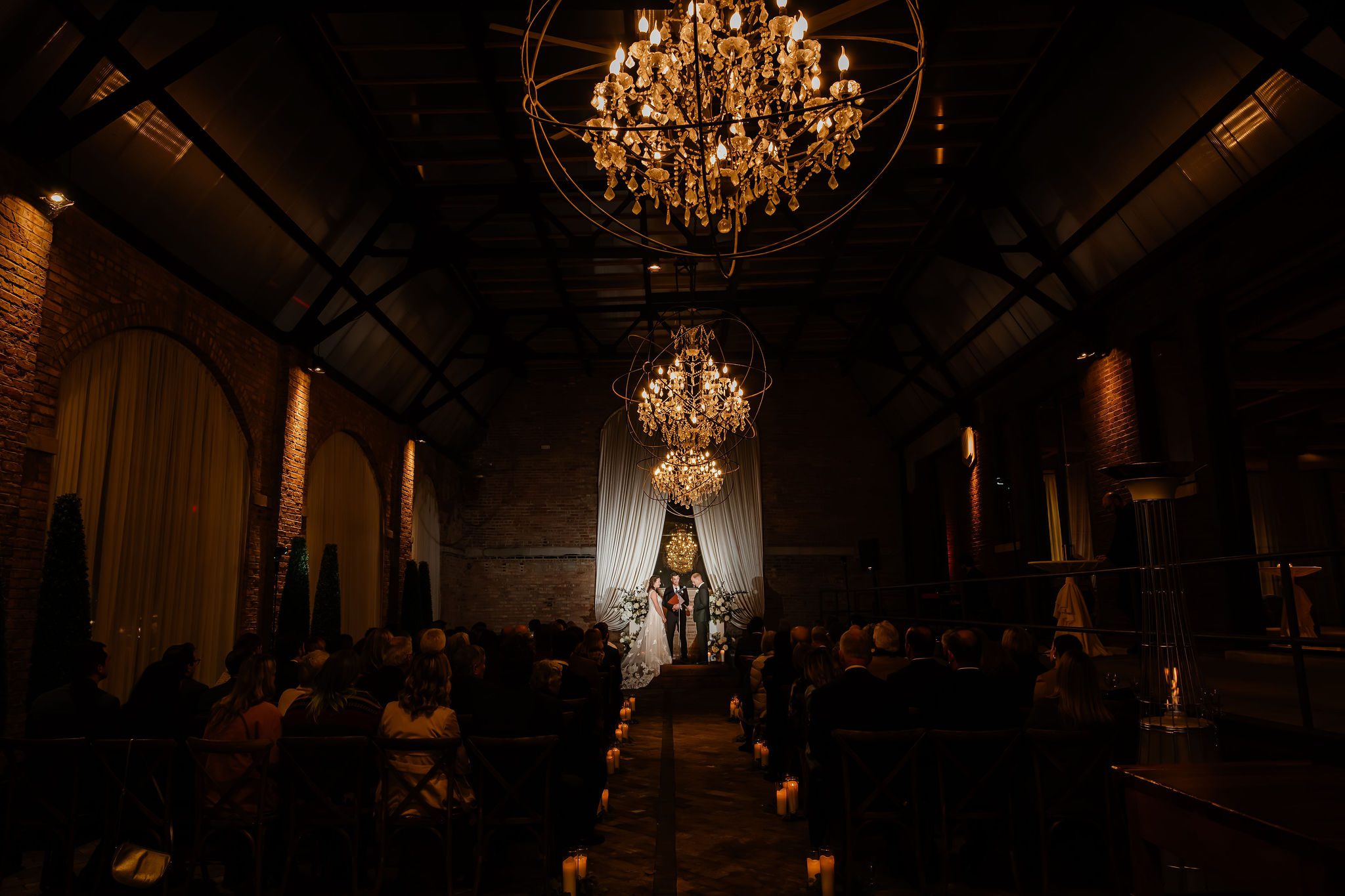 Bride an groom get married at night at the Bridgeport Arts Center in Chicago, IL.