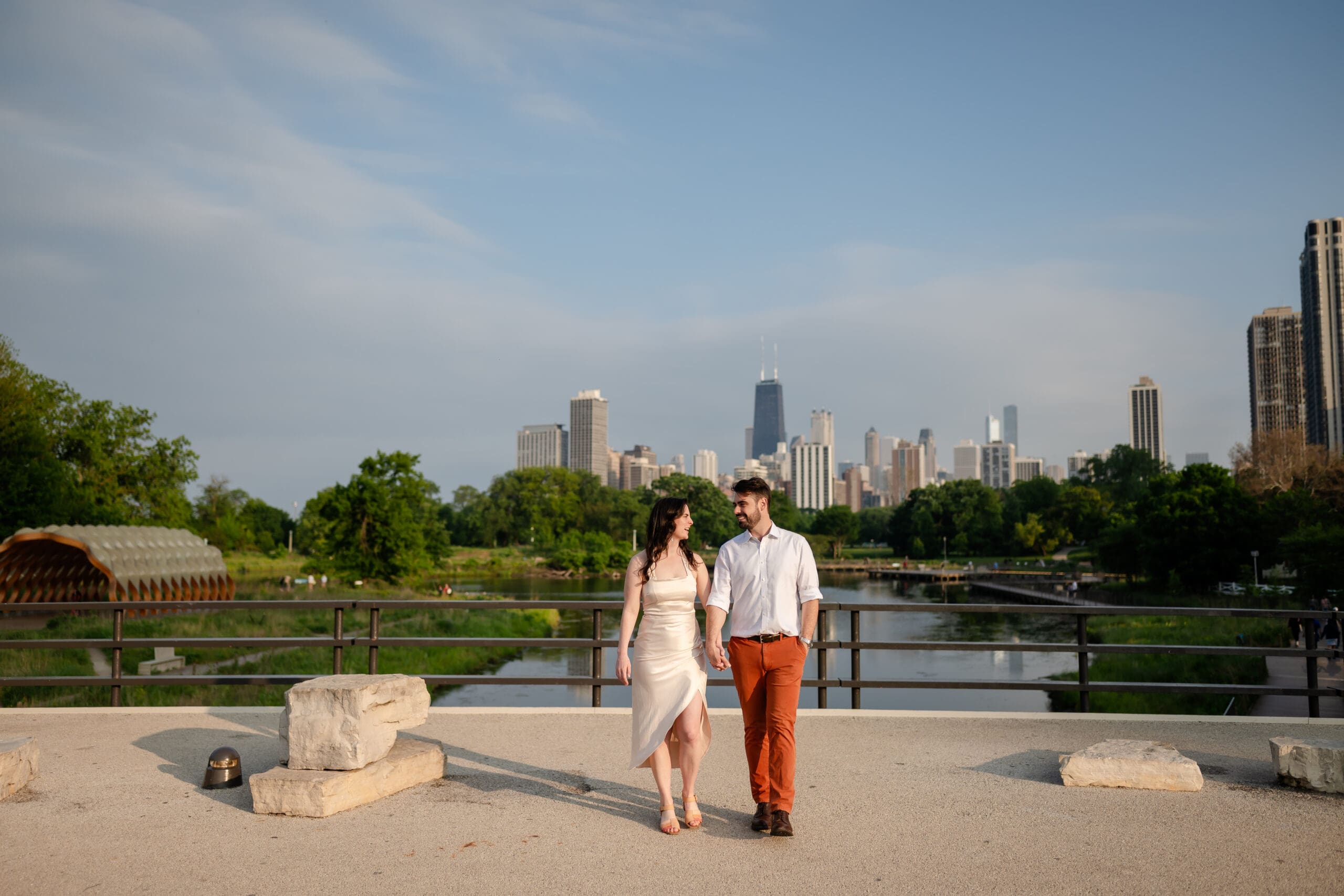 A couple holds hands and walk on the South Bridge in Lincoln Park.