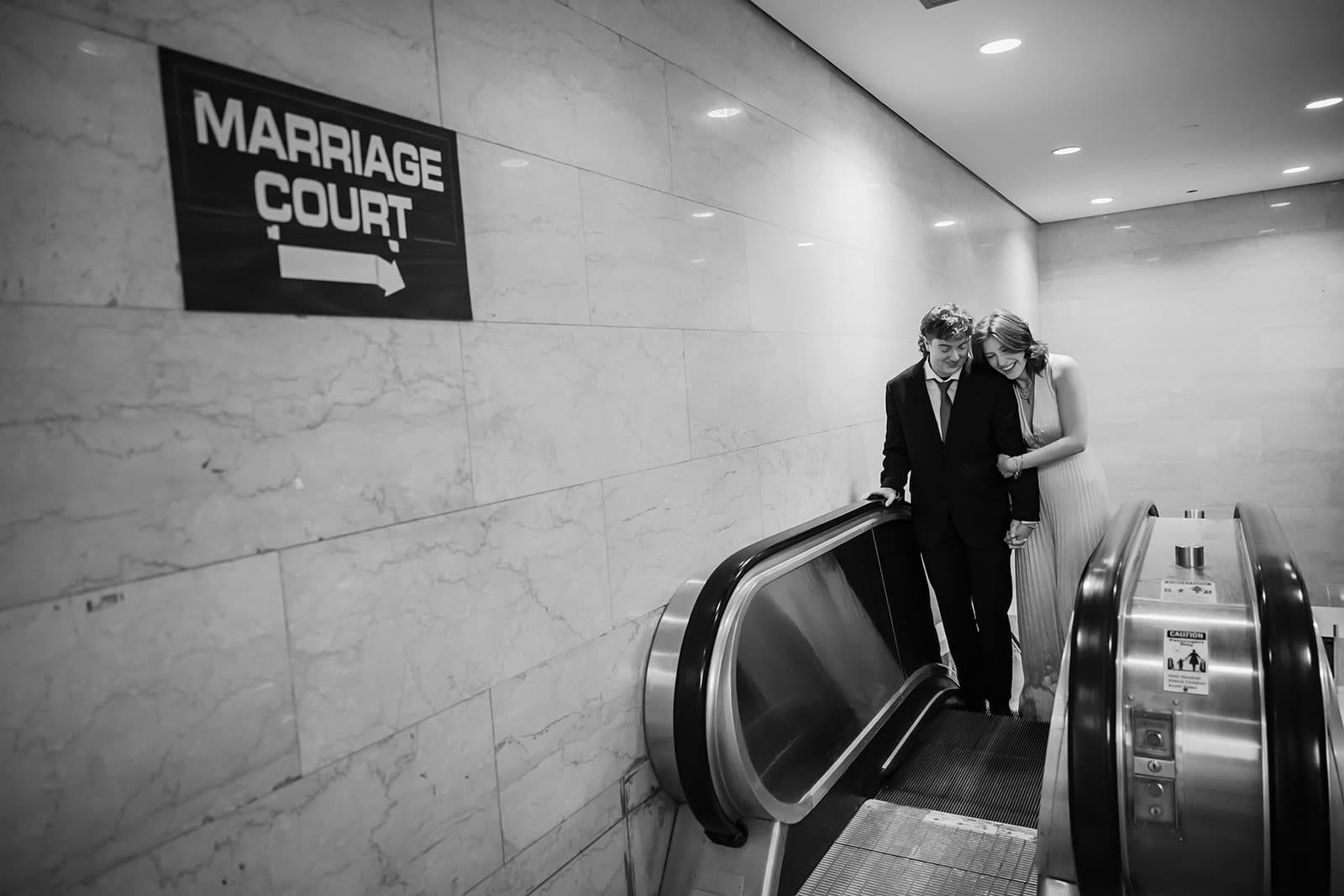 Couple embraces up the escalator at Chicago City Hall after getting married.